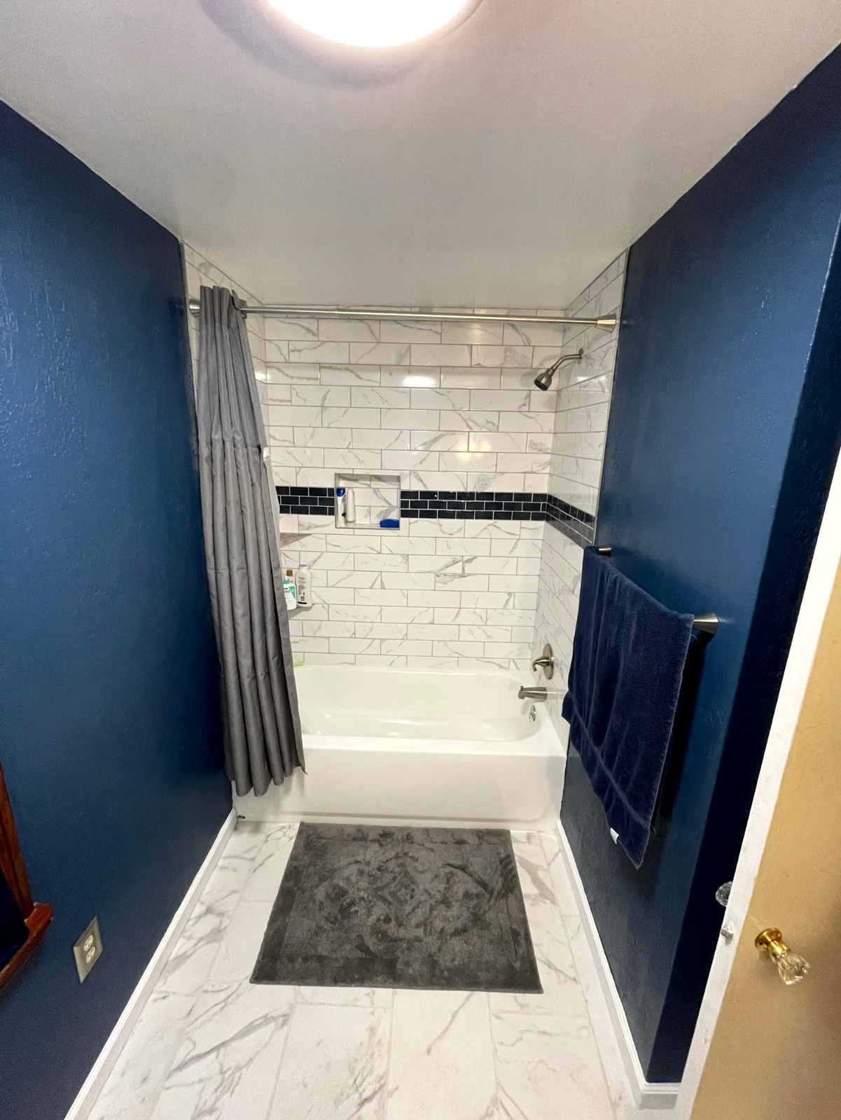 Bathroom Remodel with Navy Blue Wall, Marble Look Countertop, and Gray Vanity