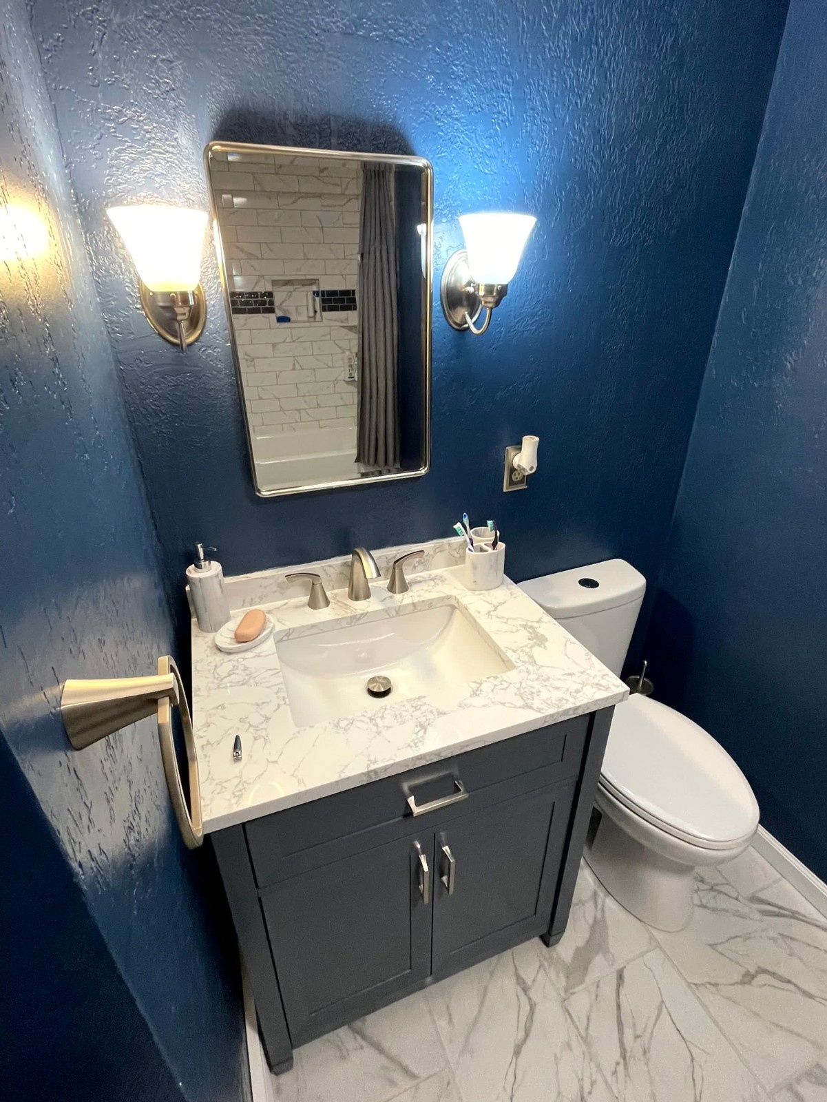 Modern Bathroom Remodel in Beaver County PA with Navy Blue Wall, Marble Look Countertop, and Gray Vanity