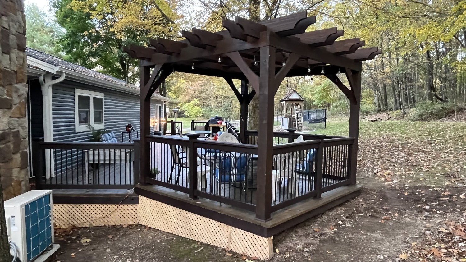 SC Projects LLC installs an accessibility ramp and deck in treated wood, leading to a home entrance with their black company truck parked nearby .